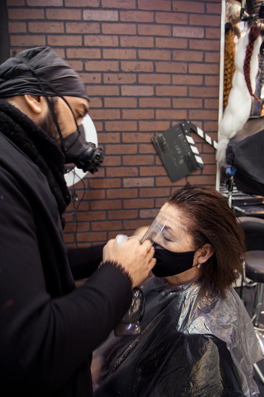 Stylist working on a client's hair in a salon